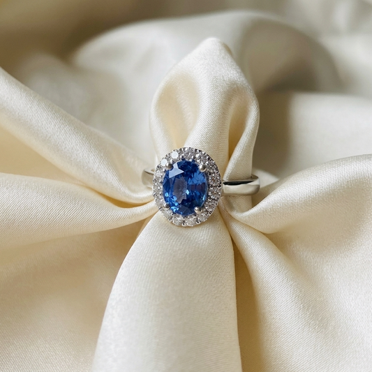 Oval Ceylon blue sapphire and diamond halo ring - side view