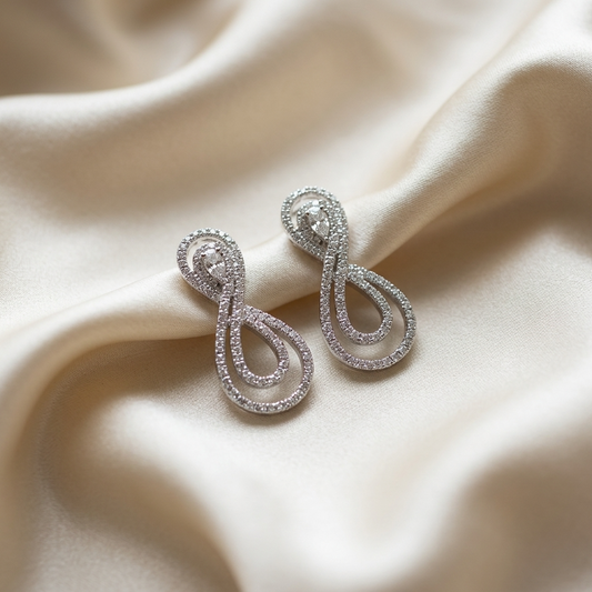 Pear shape diamond swirl earrings - angled view