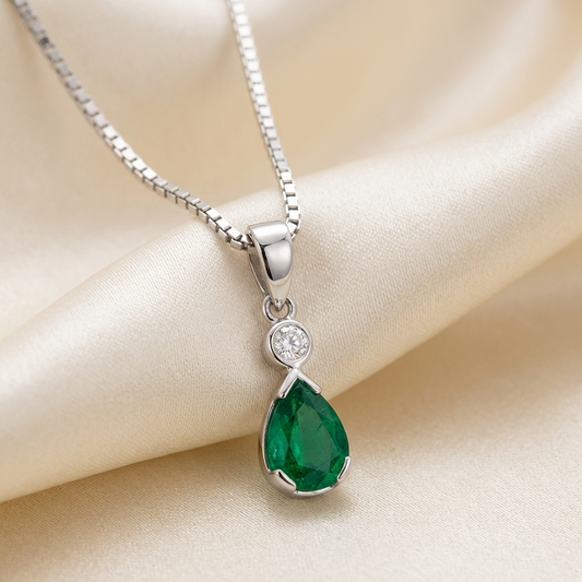 Pear shape emerald and diamond pendant - angled view