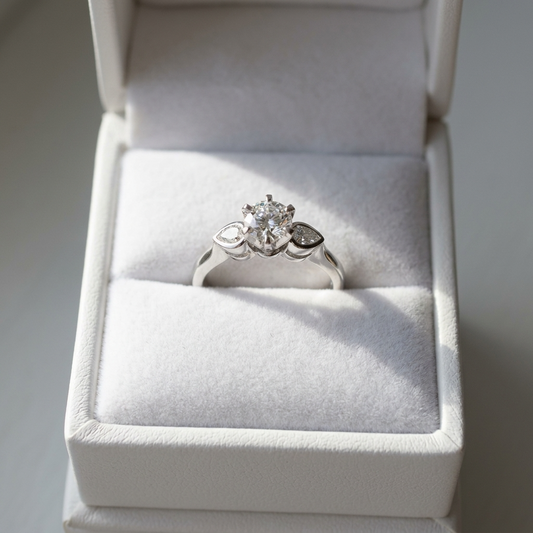 Lauren round brilliant diamond three stone engagement ring with pear shape shoulder stones, front view