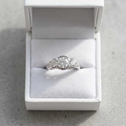 Coralie round brilliant diamond three stone engagement ring, profile view