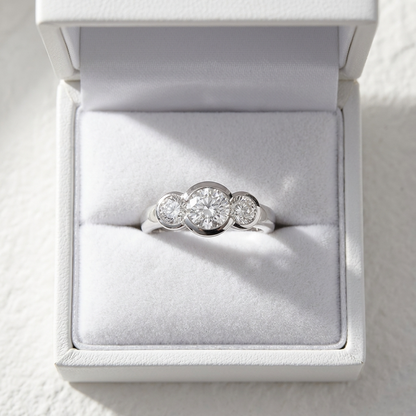 Coralie round brilliant diamond three stone engagement ring, raised view
