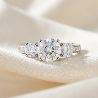Clemence round brilliant diamond three stone engagement ring on white gold band