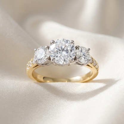 Penelope round brilliant diamond three stone engagement ring, raised view