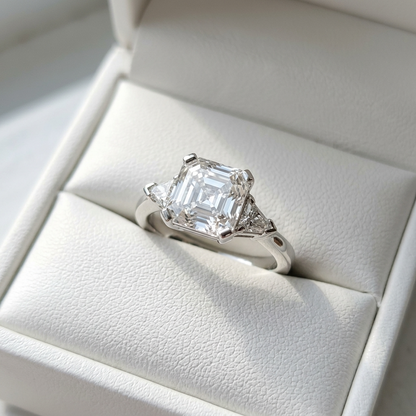 Beatrix Asscher cut diamond three stone engagement ring, angled view