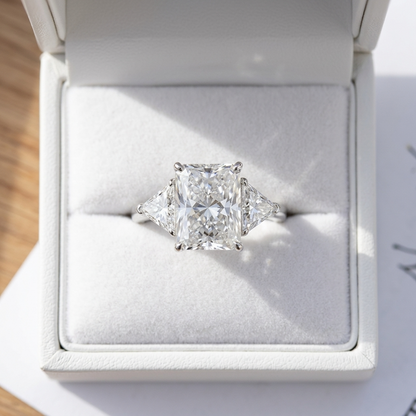 Delphine radiant cut diamond three stone engagement ring, side view