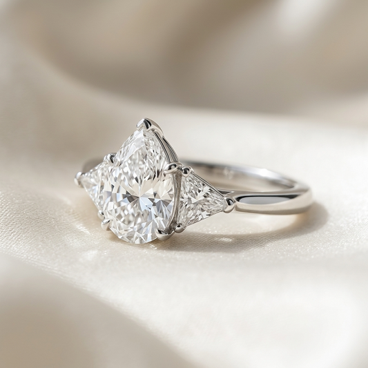 Genevieve pear shaped diamond three stone engagement ring, angled view