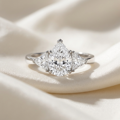 Genevieve pear shaped diamond three stone engagement ring, side view