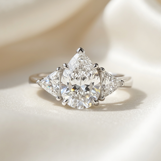 Genevieve pear shaped diamond three stone engagement ring in white gold