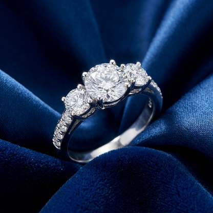 Clemence round brilliant diamond three stone engagement ring, close view