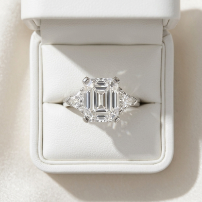 Estelle emerald cut diamond three stone ring with trilliant sides, top view