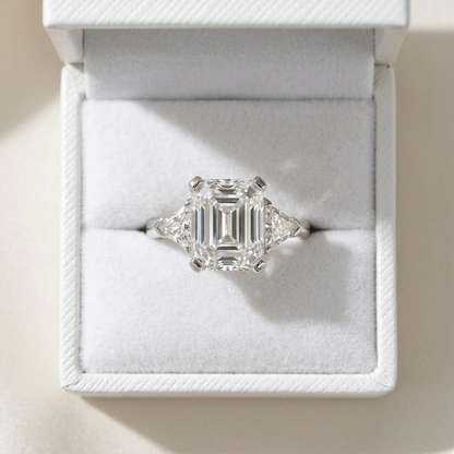 Estelle emerald cut diamond three stone ring with trilliant sides on white gold band
