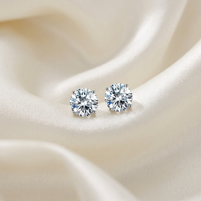 Four claw round diamond stud earrings - angled view
