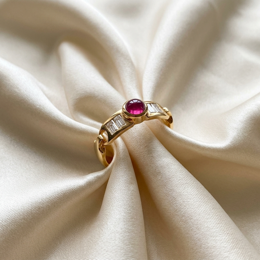 Cabochon ruby and baguette diamond buckle ring in 18ct yellow gold