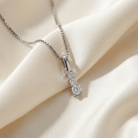 Three stone claw set round diamond pendant