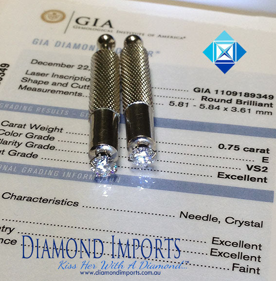 Two diamond studs on a GIA grading report sheet.