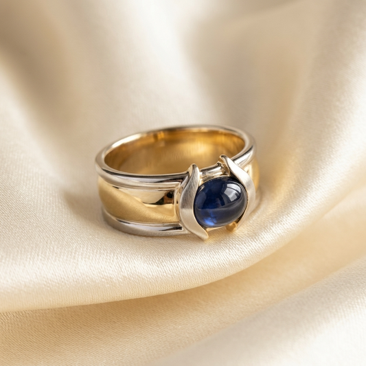 Oval cabochon Australian blue sapphire ring in two tone 18ct yellow and white gold