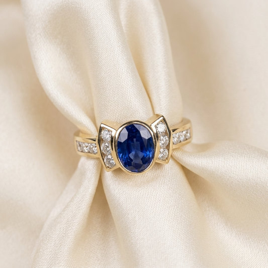 Oval Ceylon blue sapphire and diamond dress ring in 18ct yellow gold