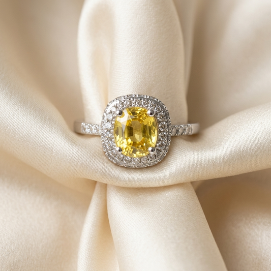 Cushion cut yellow sapphire and diamond halo ring in white gold