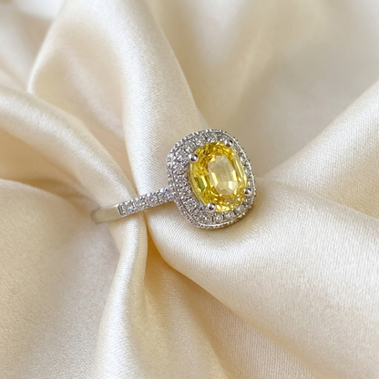 Cushion cut yellow sapphire and diamond halo ring in white gold - detail view