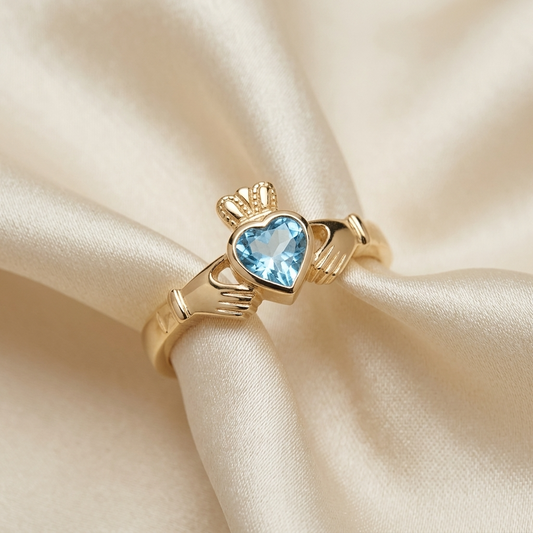 Blue topaz Claddagh dress ring in yellow gold