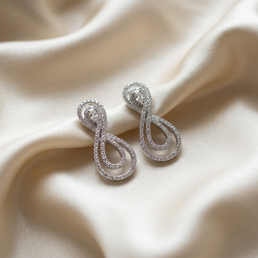 Pear shape diamond swirl earrings - angled view