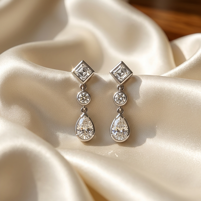 Pear shape and square diamond drop earrings - close up