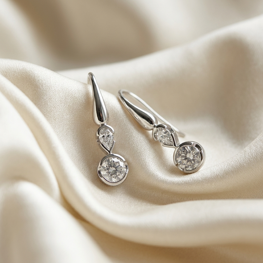 Pear shape and round diamond drop earrings - angled view