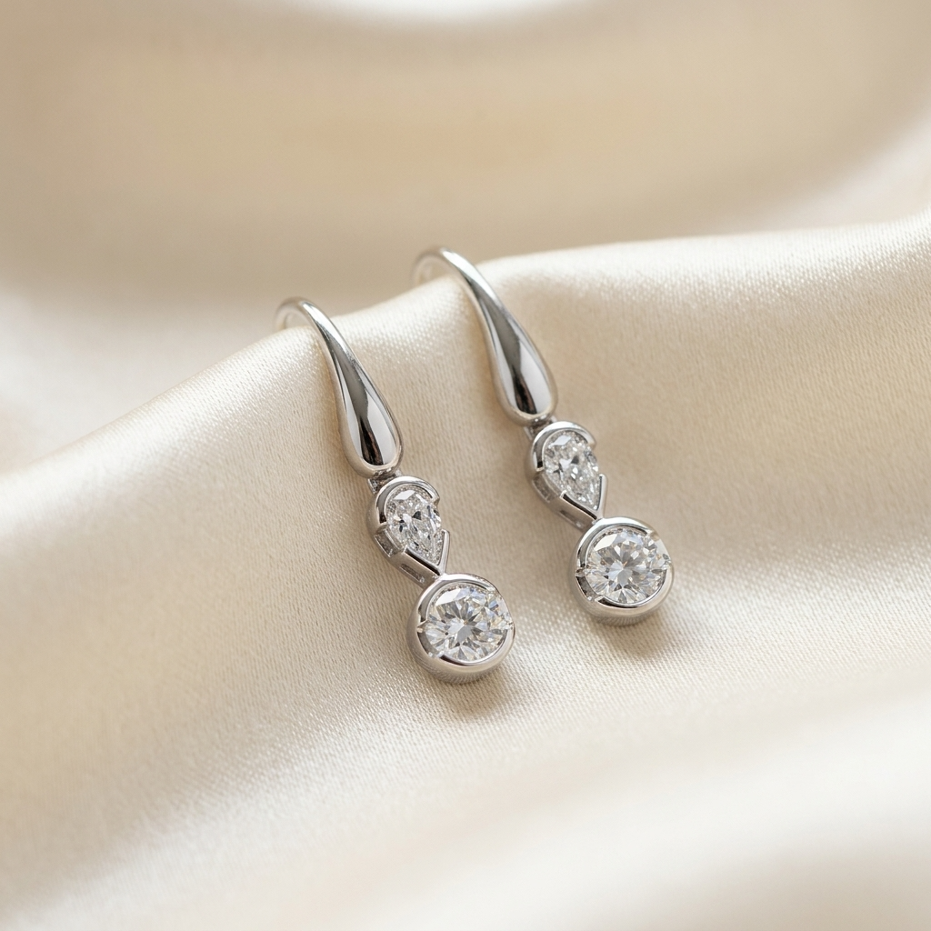 Pear shape and round diamond drop earrings - detail view