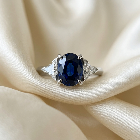 Oval sapphire and trilliant cut diamond trilogy engagement ring in white gold — handcrafted in Sydney