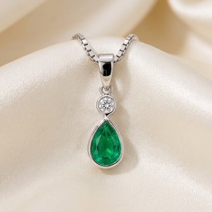 Pear shape bezel set emerald and diamond pendant - detail view