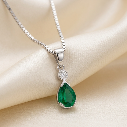 Pear shape emerald and diamond pendant - angled view