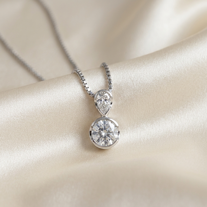 Pear shape and round diamond pendant - detail view