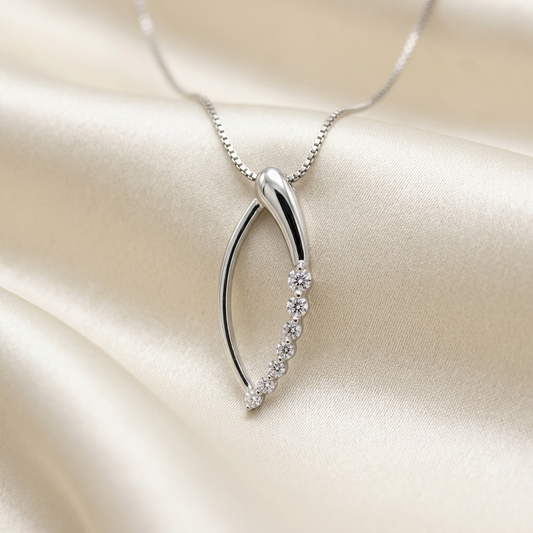 Marquise shape diamond pendant set with round brilliant diamonds