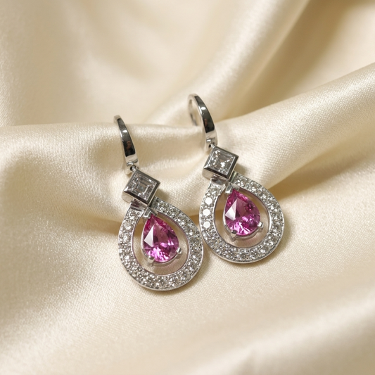 Pink sapphire and diamond halo drop earrings - angled view