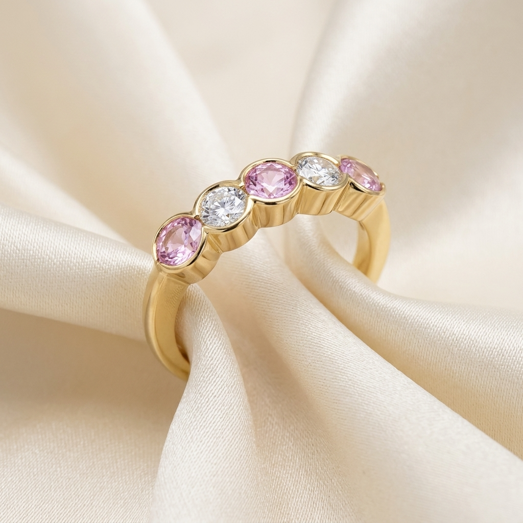 Pink sapphire and diamond eternity ring - angled view