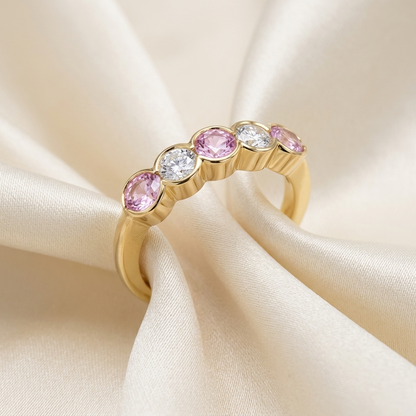 Pink sapphire and diamond eternity ring - angled view