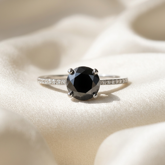 Black diamond solitaire engagement ring with diamond side stones in 14ct white gold