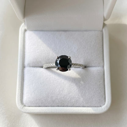 Black diamond solitaire engagement ring with diamond side stones, side view