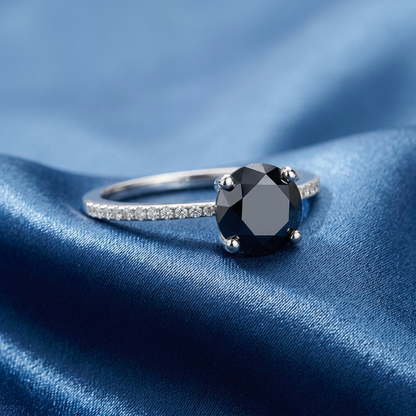 Black diamond solitaire engagement ring with diamond side stones, top view