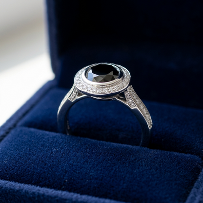 Black diamond bezel set halo engagement ring, top view