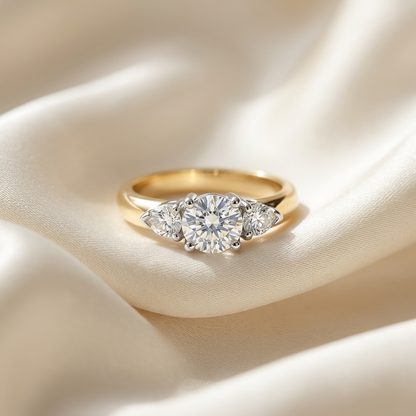 Shayla round brilliant diamond three stone engagement ring with pear shape side stones, three quarter view