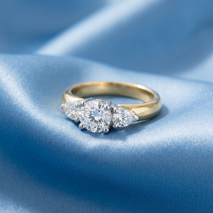 Shayla round brilliant diamond three stone engagement ring with pear shape side stones, raised view