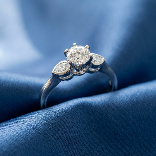 Lauren round brilliant diamond three stone engagement ring with pear shape shoulder stones in 18ct white gold
