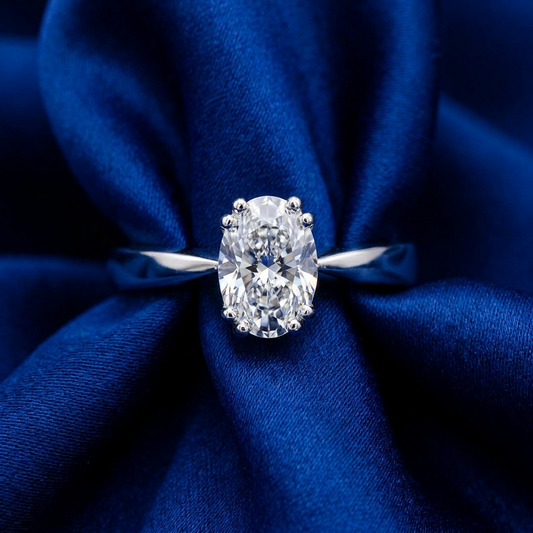 Oval diamond solitaire engagement ring on a slender polished band