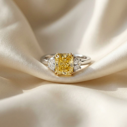 Fancy yellow radiant diamond ring with half moon side stones - detail view