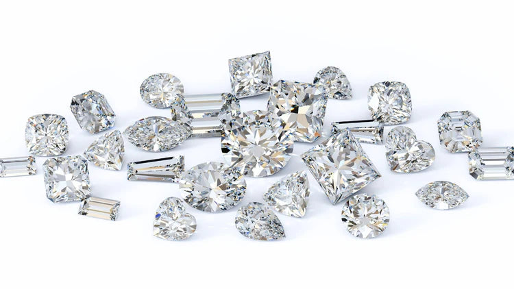 Collection of various cut diamonds on a white background